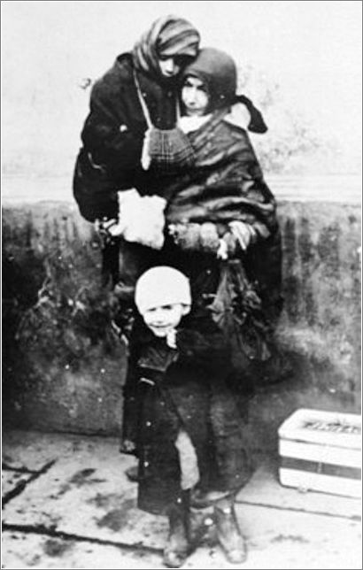 A Jewish woman and her two young children await deportation from the Krakow ghetto